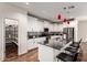 Bright kitchen features white cabinets, dark granite countertops, stainless steel appliances, and walk-in pantry at 2391 S 171St Ln, Goodyear, AZ 85338