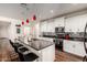 Stylish kitchen featuring an island with bar seating, modern appliances, and striking pendant lighting at 2391 S 171St Ln, Goodyear, AZ 85338