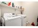 Laundry room featuring white washer and dryer, plus shelving at 2391 S 171St Ln, Goodyear, AZ 85338