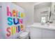 Bright bathroom featuring a stylish 'Hello Sunshine' shower curtain at 2494 N Heritage St, Buckeye, AZ 85396