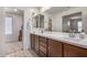 Double sink bathroom with stylish tile flooring, modern fixtures, and ample lighting at 2494 N Heritage St, Buckeye, AZ 85396