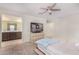 Bedroom with ensuite bathroom, dresser with TV, and neutral color scheme at 2494 N Heritage St, Buckeye, AZ 85396