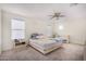 Spacious bedroom with neutral carpet, ceiling fan, and large windows for ample natural light at 2494 N Heritage St, Buckeye, AZ 85396