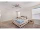 Bright bedroom showcasing neutral decor, plush carpeting, and a ceiling fan at 2494 N Heritage St, Buckeye, AZ 85396