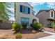 Beautiful two-story home with a light-colored exterior, blue shutters, and well-maintained front yard landscaping at 2494 N Heritage St, Buckeye, AZ 85396