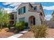 Inviting two-story home showcasing a stucco exterior, red tile roof, and a welcoming arched entryway at 2494 N Heritage St, Buckeye, AZ 85396