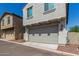 Attached two-car garage with a beige door and clean driveway at 2494 N Heritage St, Buckeye, AZ 85396