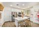 Modern kitchen boasting white cabinetry, stainless steel appliances, and a center island with bar seating at 2494 N Heritage St, Buckeye, AZ 85396