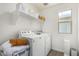 Clean laundry room with modern washer and dryer units at 2494 N Heritage St, Buckeye, AZ 85396
