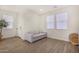 Bright living room with stylish wood-look tile flooring, neutral walls, and a comfortable gray sofa at 2494 N Heritage St, Buckeye, AZ 85396
