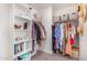 Organized walk-in closet with shelving and hanging space for optimal storage solutions at 2494 N Heritage St, Buckeye, AZ 85396