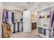 Well-organized walk-in closet leading to the bathroom and providing ample storage space at 2494 N Heritage St, Buckeye, AZ 85396