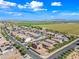 Aerial view showcases the residential community with solar panels, neat landscaping, and tranquil surroundings at 25657 W Beth Dr, Buckeye, AZ 85326