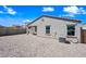 An enclosed gravel backyard featuring a covered patio with comfortable outdoor seating, perfect for relaxation and entertaining at 25657 W Beth Dr, Buckeye, AZ 85326