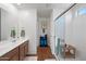 Bathroom featuring a glass enclosed shower, a vanity with double sinks, and wood look floors at 25657 W Beth Dr, Buckeye, AZ 85326