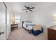 Cozy bedroom with carpeted floors, a ceiling fan, and a window with natural light at 25657 W Beth Dr, Buckeye, AZ 85326