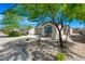 Charming front exterior of the home with a well-kept yard, desert landscaping and attached garage at 25657 W Beth Dr, Buckeye, AZ 85326