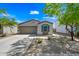 Charming single-story home with a well-manicured front yard, desert landscaping, and a two-car garage at 25657 W Beth Dr, Buckeye, AZ 85326