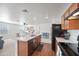 Open kitchen with stainless steel appliances, a central island, and a seamless transition to the living area at 25657 W Beth Dr, Buckeye, AZ 85326