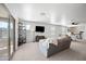Open living space with plush seating, a large TV, and a sliding glass door to the outside, showcasing contemporary style at 25657 W Beth Dr, Buckeye, AZ 85326