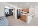Open-concept living space with a view of the kitchen, featuring stainless steel appliances and modern finishes at 25657 W Beth Dr, Buckeye, AZ 85326