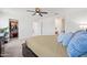 Spacious main bedroom featuring a ceiling fan, walk-in closet, and ensuite bathroom at 25657 W Beth Dr, Buckeye, AZ 85326