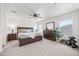Spacious primary bedroom featuring a ceiling fan, plush carpet, and windows for natural light at 25657 W Beth Dr, Buckeye, AZ 85326