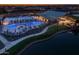 Aerial view of the community pool area featuring multiple pools, seating, and a pond at 26047 S 228Th Pl, Queen Creek, AZ 85142