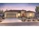 Inviting single-story home featuring a two-car garage, desert landscaping, and a charming front entrance at 26936 W Mcrae Dr, Buckeye, AZ 85396