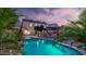 Lush backyard featuring a sparkling pool, a pergola, mature landscaping, and solar panels at 28021 N 23Rd Dr, Phoenix, AZ 85085