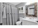 Well-lit bathroom featuring a mirror, under sink storage, and a shower-tub combo at 28021 N 23Rd Dr, Phoenix, AZ 85085