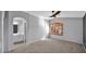 Bright bedroom with light gray walls, a ceiling fan, an arched window, and an en-suite bathroom with white vanity at 28021 N 23Rd Dr, Phoenix, AZ 85085