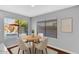 Cozy dining area with a round table, four chairs, and natural light from backyard view at 28021 N 23Rd Dr, Phoenix, AZ 85085