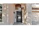Close-up of the front door featuring a glass block detail and stylish exterior lighting at 28021 N 23Rd Dr, Phoenix, AZ 85085
