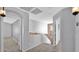Inviting hallway with carpet flooring and clear sightlines to a brick-walled room at 28021 N 23Rd Dr, Phoenix, AZ 85085
