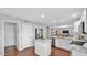 Spacious kitchen that offers stainless appliances, white cabinetry and an island, connecting to the living space at 28021 N 23Rd Dr, Phoenix, AZ 85085
