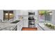Modern kitchen with stainless steel appliances, granite countertops, and bright white cabinets at 28021 N 23Rd Dr, Phoenix, AZ 85085