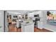Open kitchen showcasing a center island, granite counters, stainless appliances, and living space at 28021 N 23Rd Dr, Phoenix, AZ 85085