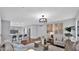 Open-concept living area featuring hardwood floors, modern lighting, and comfortable seating at 28021 N 23Rd Dr, Phoenix, AZ 85085