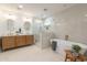 Well-lit bathroom featuring double sink vanity, marble tile and glass-enclosed shower at 3651 N 49Th Pl, Phoenix, AZ 85018