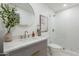 Updated bathroom showcasing vanity, marble countertop, round mirror, and tiled shower at 3651 N 49Th Pl, Phoenix, AZ 85018