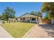 Charming home with a manicured lawn, beautiful landscaping, and a inviting front porch swing at 3651 N 49Th Pl, Phoenix, AZ 85018