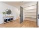 Hallway with views of large shelved pantry, gray accent doors and wood-look flooring at 3651 N 49Th Pl, Phoenix, AZ 85018