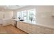 Bright kitchen boasts white cabinets, stone countertops, and new stainless appliances at 3651 N 49Th Pl, Phoenix, AZ 85018