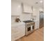 Gourmet kitchen with stainless steel gas range, custom cabinets, and sleek countertops at 3651 N 49Th Pl, Phoenix, AZ 85018