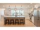Open layout kitchen featuring a large center island with seating and pendant lighting at 3651 N 49Th Pl, Phoenix, AZ 85018