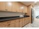 Bright laundry room with abundant cabinets, dark countertop, and modern washer/dryer at 3651 N 49Th Pl, Phoenix, AZ 85018