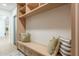 Cozy mudroom with custom built-in shelving, bench seating, and stylish throw pillows at 3651 N 49Th Pl, Phoenix, AZ 85018