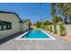 Backyard swimming pool with gray pavers and lush landscaping; perfect for hot summer days at 3651 N 49Th Pl, Phoenix, AZ 85018