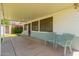 Covered back patio featuring tiled floor and plastic chairs and foliage at 4140 E Glenrosa Ave, Phoenix, AZ 85018